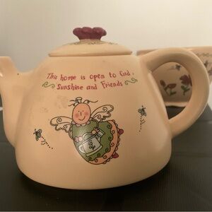 Adorable matching Teapot sits on matching teacup, “Sunshine & Friends”
New